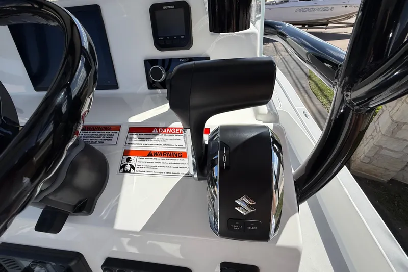 Slide: The Image of Control panel of 2026 Shallow Sport 25 X3 boat with Suzuki throttle. - 30