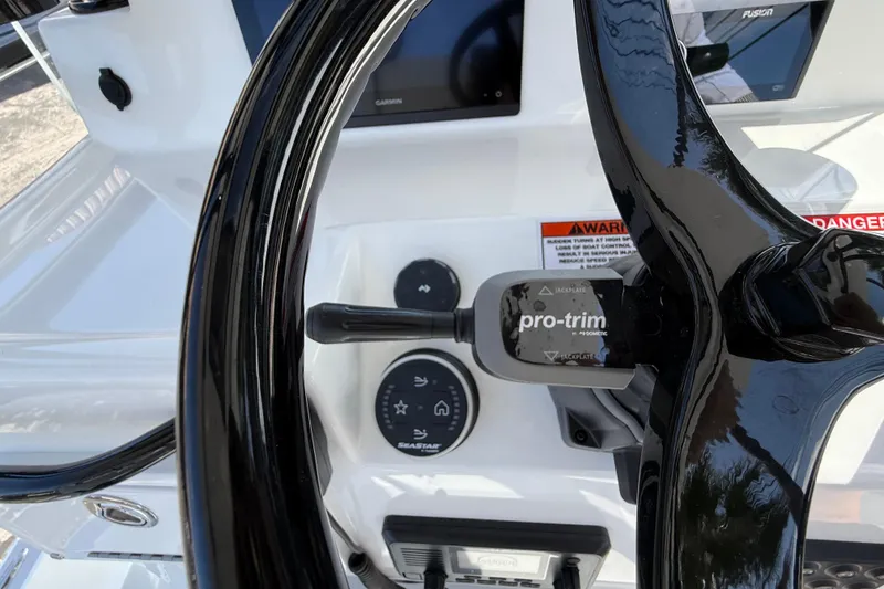 Slide: The Image of Steering wheel and controls of 2026 Shallow Sport 25 X3 boat cockpit. - 31