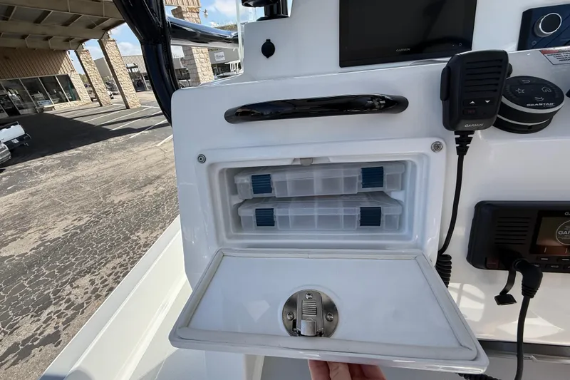 Slide: The Image of Shallow Sport 25 X3 boat console with storage compartments and electronic controls, 2026 model. - 33