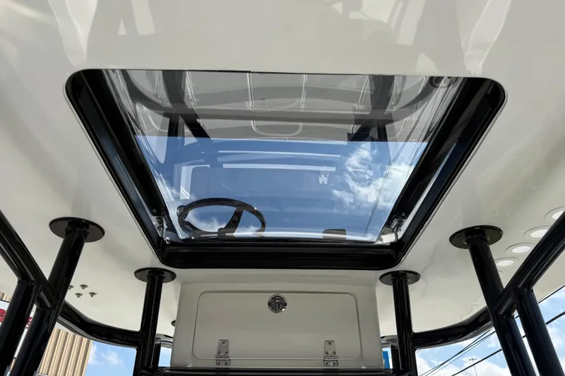 Slide: The Image of 2026 Shallow Sport 25 X3 boat interior with glass roof and steering wheel. - 37