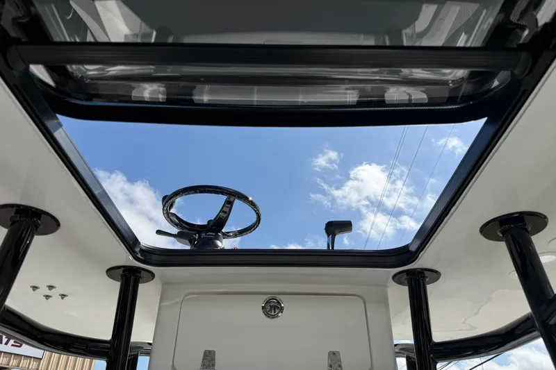 Slide: The Image of View through the sunroof of a 2026 Shallow Sport 25 X3 boat, showing steering wheel and sky. - 38