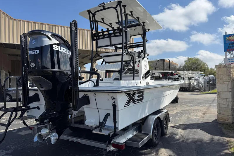 Slide: The Image of 2026 Shallow Sport 25 X3 boat with Suzuki 350 engine on trailer. - 4