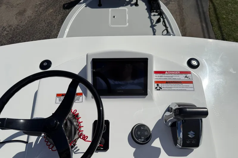 Slide: The Image of Steering console of 2026 Shallow Sport 25 X3 boat with controls and display. - 40