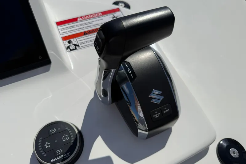 Slide: The Image of Close-up of 2026 Shallow Sport 25 X3 boat controls with Suzuki throttle and SeaStar system. - 42