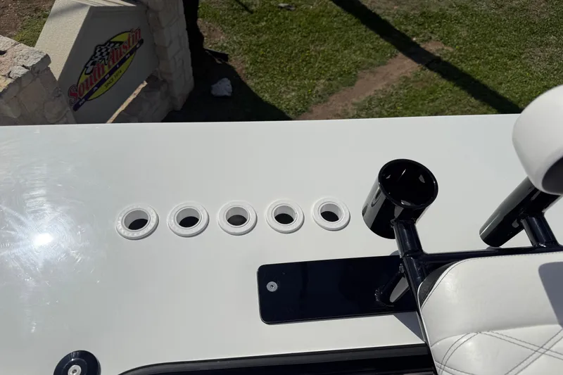 Slide: The Image of 2026 Shallow Sport 25 X3 boat deck with rod holders and cup holder. - 44