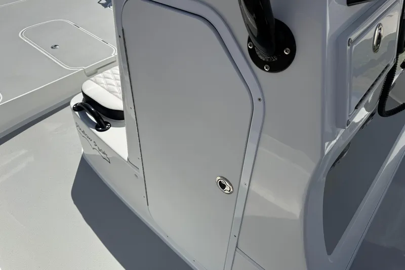 Slide: The Image of 2026 Shallow Sport 25 X3 boat interior with sleek white design and seating. - 46