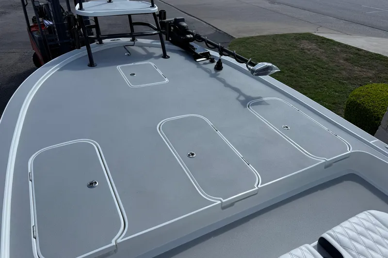 Slide: The Image of 2026 Shallow Sport 25 X3 boat deck with storage compartments and trolling motor. - 53