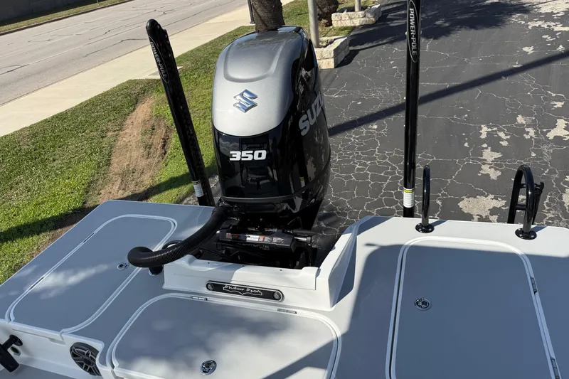 Slide: The Image of 2026 Shallow Sport 25 X3 boat with Suzuki 350 engine, parked on pavement. - 7