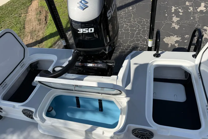 Slide: The Image of 2026 Shallow Sport 25 X3 boat with Suzuki 350 engine and open storage compartments. - 8