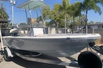 Slide: The Image of 2018 Sportsman Island Bay 18 boat on trailer, parked outdoors under sunny skies. - 1
