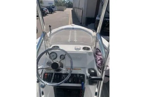 Slide: The Image of 2018 Sportsman Island Bay 18 boat dashboard with steering wheel and controls. - 2