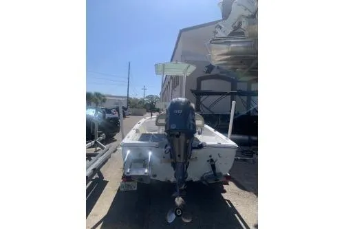 Slide: The Image of 2018 Sportsman Island Bay 18 boat with outboard motor, parked outdoors. - 6