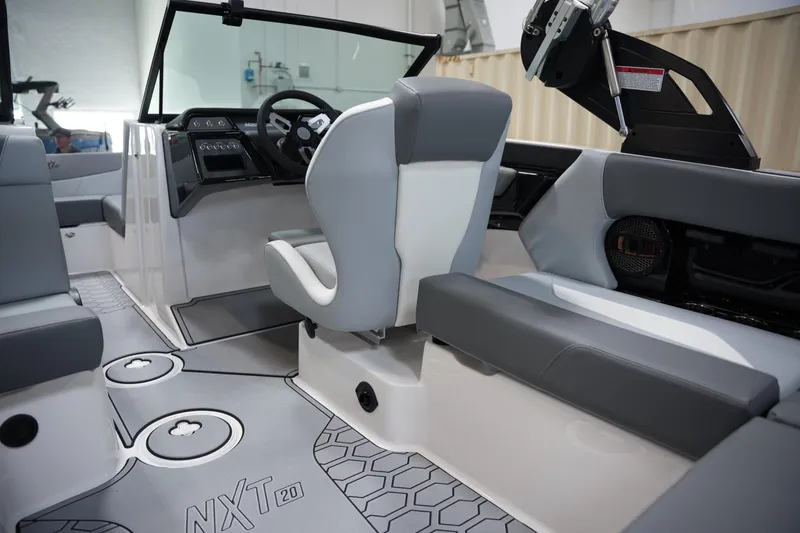 Slide: The Image of 2025 MasterCraft NXT20 boat interior with modern seating and sleek dashboard design. - 13