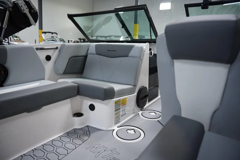 Slide: The Image of 2025 MasterCraft NXT20 boat interior with gray seating and modern design. - 14