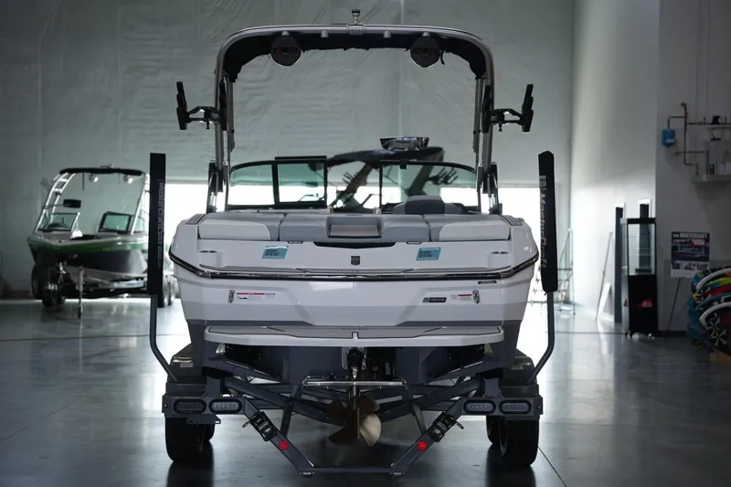 Slide: The Image of 2025 MasterCraft NXT20 boat on trailer in showroom setting. - 3