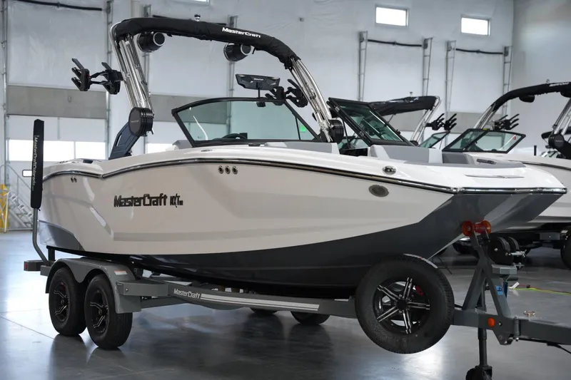 Slide: The Image of 2025 MasterCraft NXT20 boat on trailer in showroom. - 5
