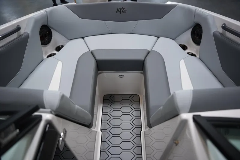 Slide: The Image of 2025 MasterCraft NXT20 boat interior with gray seating and hexagonal floor design. - 8