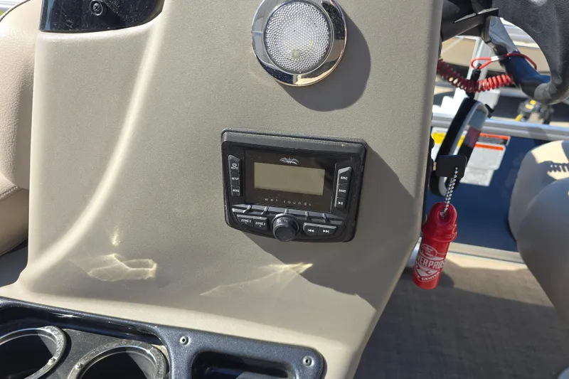 Slide: The Image of 2024 Sun Tracker Bass Buggy 16 XL Select dashboard with stereo system and cup holders. - 10