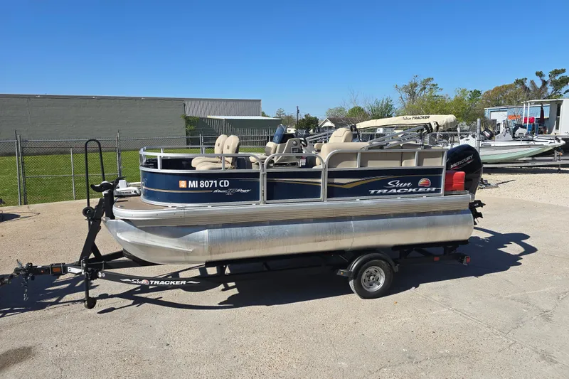 Slide: The Image of 2024 Sun Tracker Bass Buggy 16 XL Select steering console with cup holders and navigation equipment. - 11