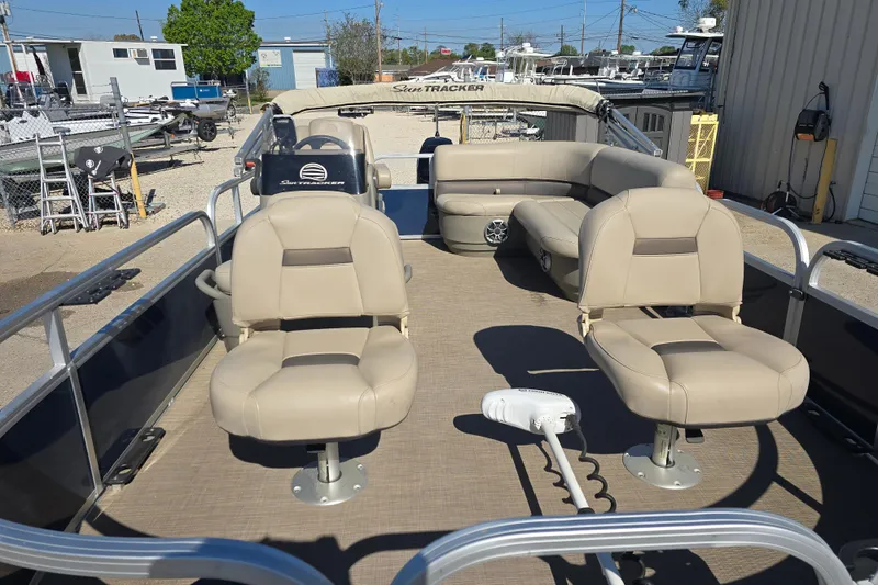 Slide: The Image of 2024 Sun Tracker Bass Buggy 16 XL Select pontoon boat with beige seating and spacious deck. - 7