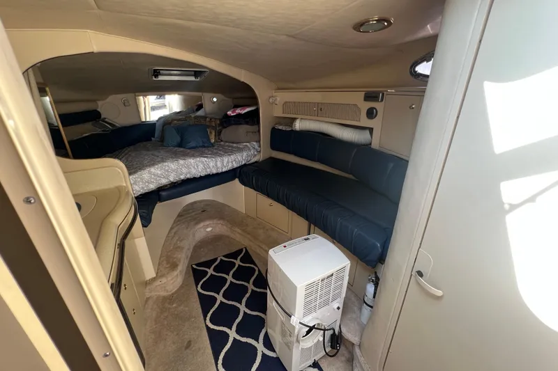 Slide: The Image of Interior of 1998 Sea Ray 290 Sundancer boat with cozy seating and sleeping area. - 12