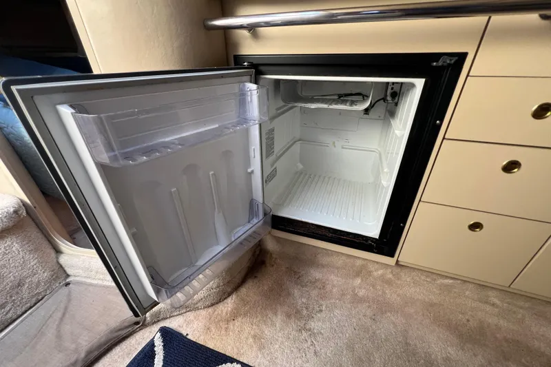 Slide: The Image of Open mini fridge inside 1998 Sea Ray 290 Sundancer boat cabin. - 17