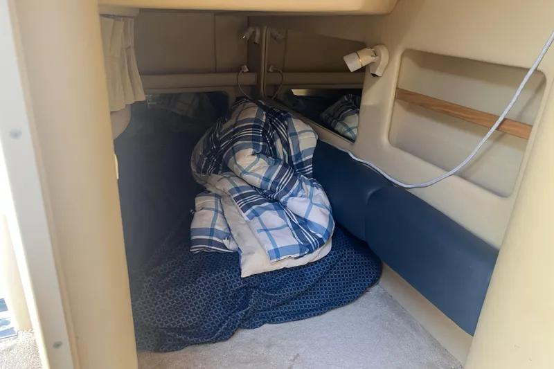 Slide: The Image of Cozy cabin interior of 1998 Sea Ray 290 Sundancer with bedding and lighting. - 20