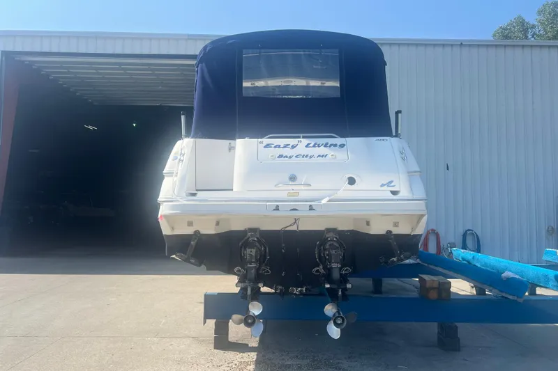 Slide: The Image of 1998 Sea Ray 290 Sundancer boat on trailer, rear view in storage facility. - 3