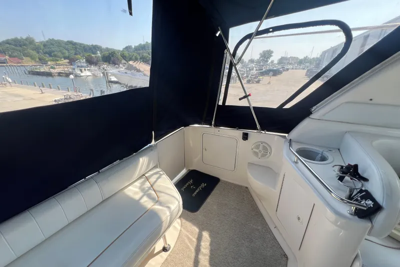 Slide: The Image of Interior view of a 1998 Sea Ray 290 Sundancer boat with seating and harbor view. - 5