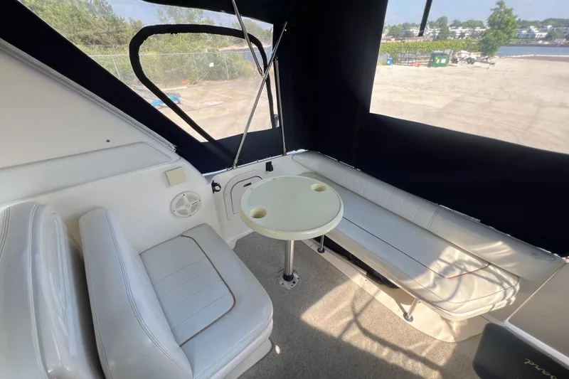 Slide: The Image of Interior of 1998 Sea Ray 290 Sundancer with seating and table setup. - 6