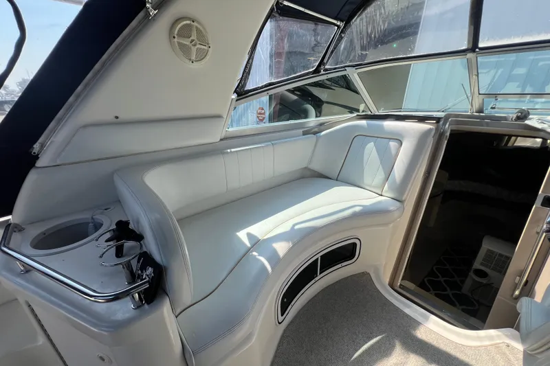 Slide: The Image of Interior of 1998 Sea Ray 290 Sundancer boat with white seating and cup holders. - 8