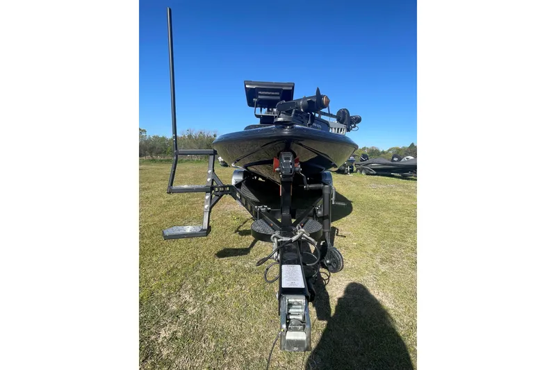 Slide: The Image of 2021 Falcon Boats F20 PREDATOR on trailer, parked on grass under clear blue sky. - 1