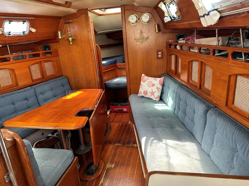 Slide: The Image of Interior of 1988 Ericson 34 sailboat with wooden furnishings and blue upholstery. - 12