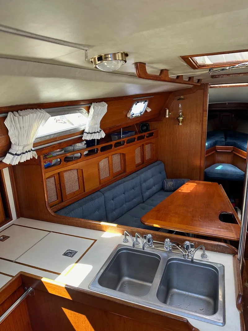 Slide: The Image of Interior of 1988 Ericson 34 sailboat with kitchen, sink, and dining area. - 14
