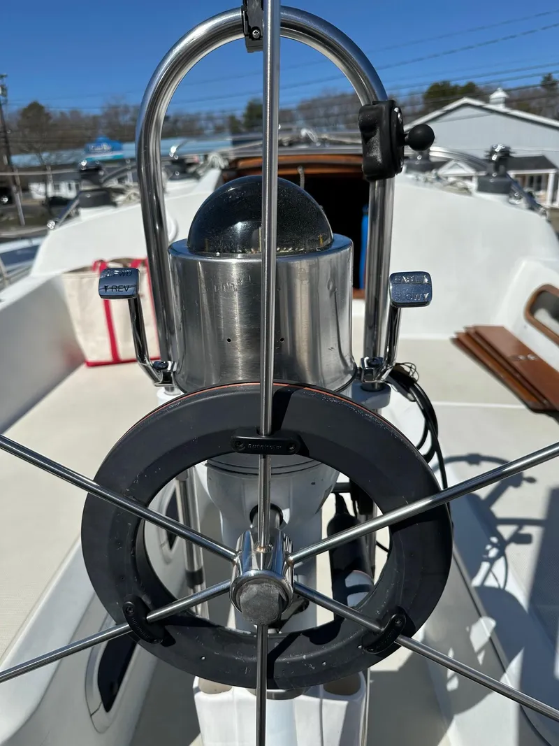Slide: The Image of 1988 Ericson 34 sailboat helm with compass and wheel. - 6