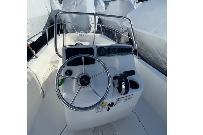Slide: The Image of 2020 Boston Whaler 170 Montauk boat interior with steering wheel and controls. - 5