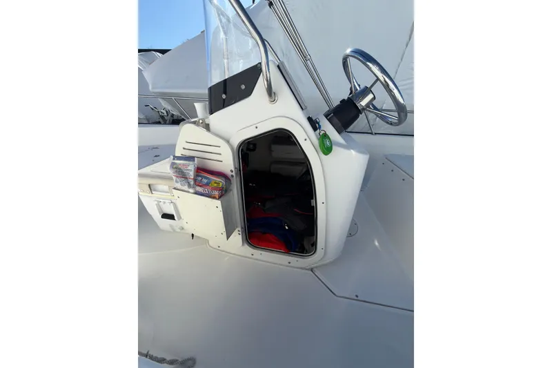Slide: The Image of 2020 Boston Whaler 170 Montauk boat console with open storage compartment. - 6