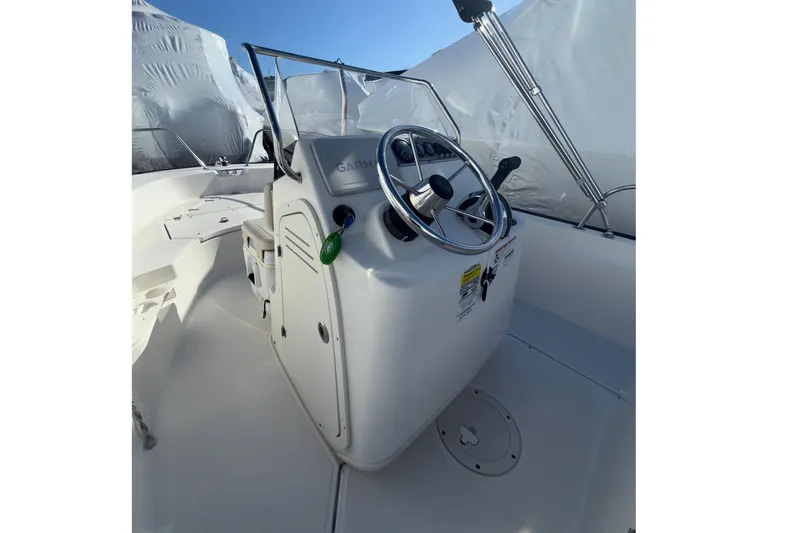 Slide: The Image of 2020 Boston Whaler 170 Montauk boat console with steering wheel and controls. - 7