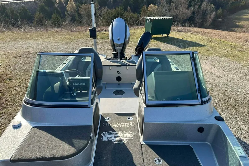 Slide: The Image of 2018 Yar-Craft 219TFX boat with windshield and Lowrance electronics, parked outdoors. - 16