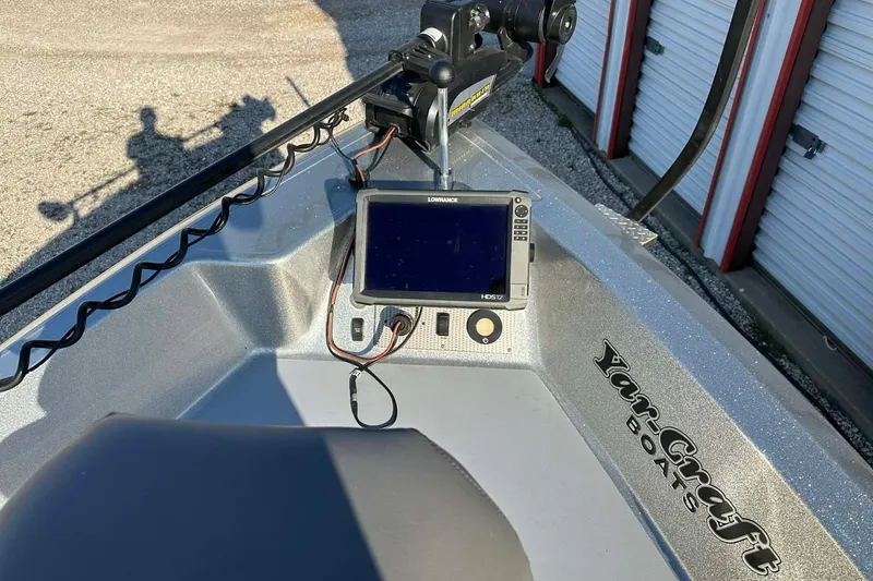 Slide: The Image of 2018 Yar-Craft 219TFX boat with navigation system and trolling motor, parked near storage units. - 22