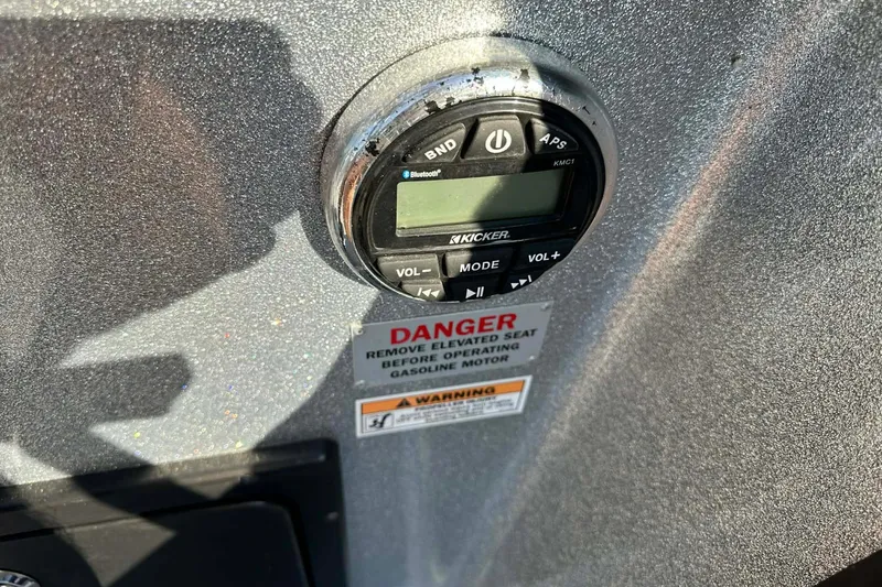 Slide: The Image of Control panel on 2018 Yar-Craft 219TFX boat with warning label and Kicker audio system. - 25