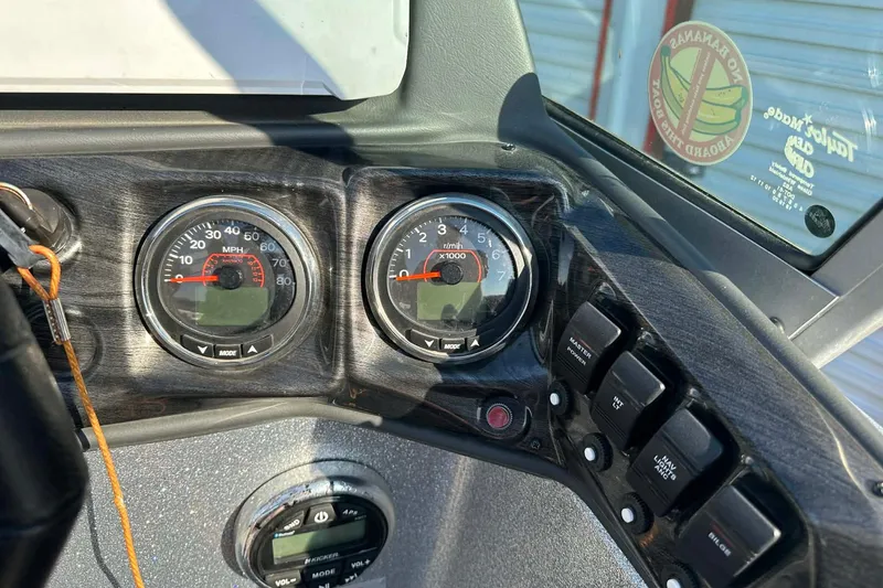 Slide: The Image of Dashboard of 2018 Yar-Craft 219TFX boat with speedometer and control switches. - 26
