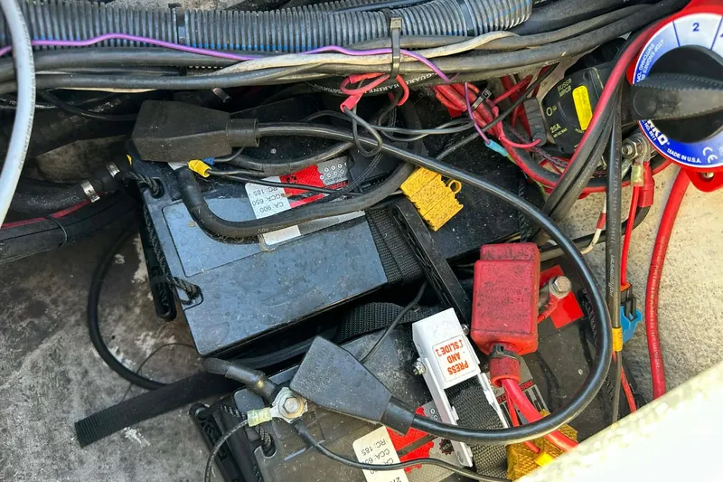 Slide: The Image of 2018 Yar-Craft 219TFX boat battery compartment with wiring and connections. - 32