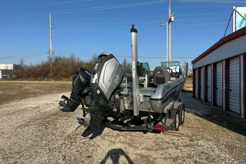 Slide: The Image of 2018 Yar-Craft 219TFX boat with Evinrude engine, parked outdoors near storage units. - 34