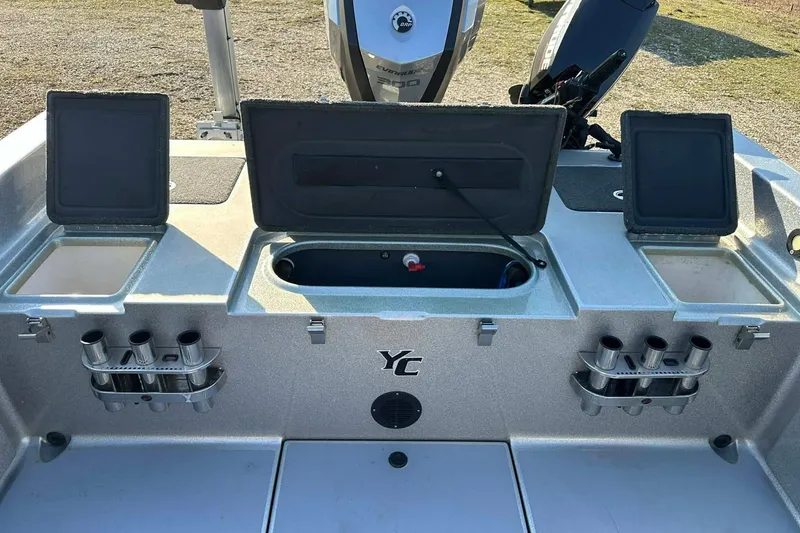 Slide: The Image of 2018 Yar-Craft 219TFX boat with open storage compartments and rod holders. - 35