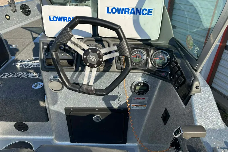 Slide: The Image of 2018 Yar-Craft 219TFX boat dashboard with steering wheel and Lowrance electronics. - 38