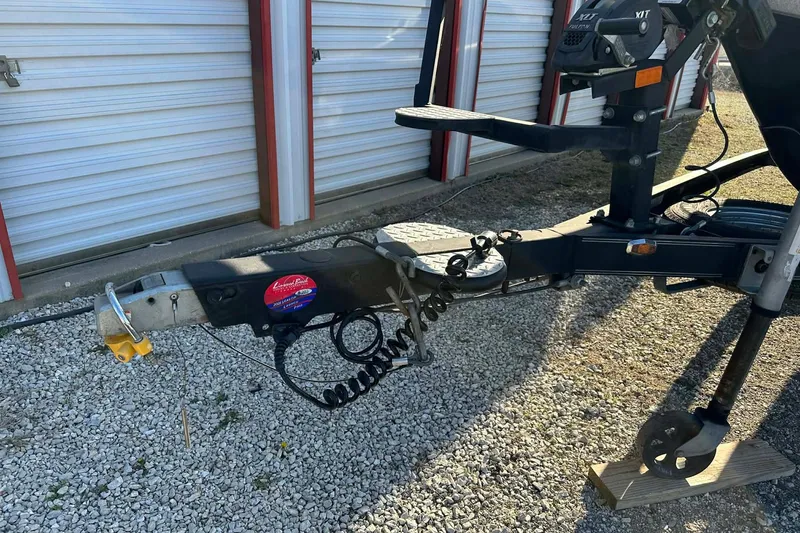 Slide: The Image of Trailer hitch of a 2018 Yar-Craft 219TFX boat, parked on gravel near storage units. - 4