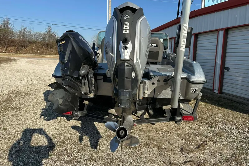 Slide: The Image of 2018 Yar-Craft 219TFX boat with dual Evinrude engines, parked outdoors. - 40