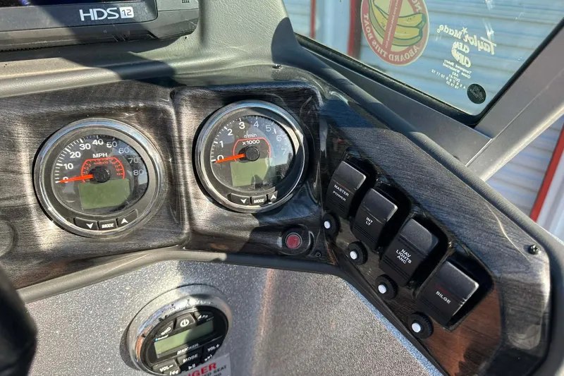 Slide: The Image of Dashboard of a 2018 Yar-Craft 219TFX boat with gauges and control switches. - 42