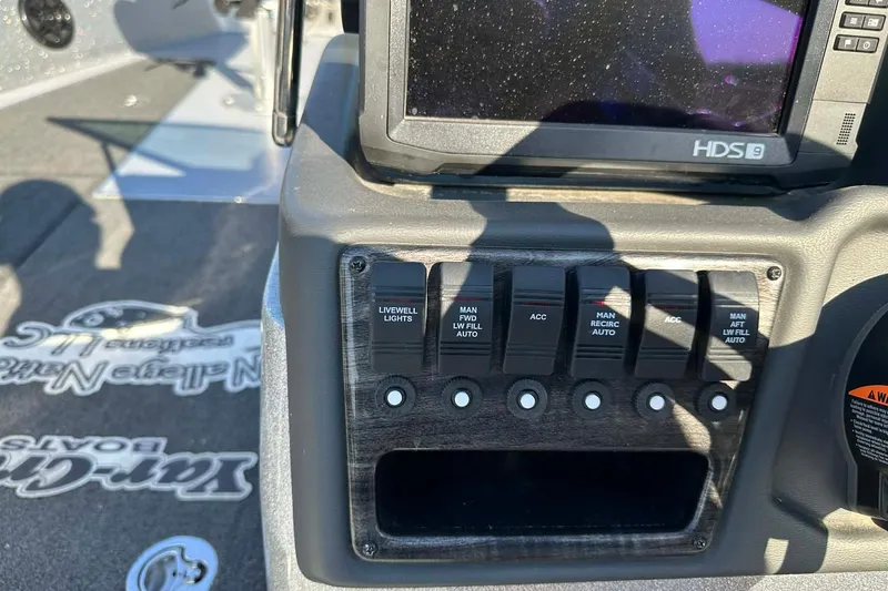 Slide: The Image of Control panel of a 2018 Yar-Craft 219TFX boat with switches and display. - 44